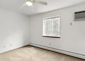 Thumbnail 29 of 38 - an empty room with a window and a ceiling fan