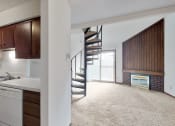Thumbnail 3 of 45 - an open living room with a kitchen and a spiral stairway leading to a loft