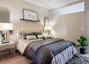 Thumbnail 9 of 25 - A bedroom with a large bed and a potted plant at The Olivia Apartments, Carmel 46032