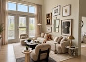Thumbnail 4 of 16 - A living room with a large window, a sofa, a chair, a coffee table, and pictures on the wall.