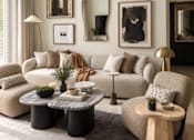 Thumbnail 3 of 16 - A living room with a grey couch, a grey coffee table, a grey rug, a wooden side table, a white chair, a white sofa, a white couch, a white wall, a white floor, a white ceiling,