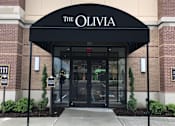 Thumbnail 22 of 25 - The entrance to a building named The Olivia with a black awning at The Olivia Apartments, Carmel, Indiana