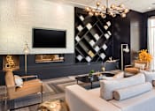 Thumbnail 14 of 25 - A modern living room with a large television and a fireplace at The Olivia Apartments, Carmel