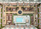Thumbnail 13 of 35 - An aerial view of a courtyard with a pool and a fountain.
