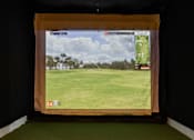 Thumbnail 30 of 35 - A golf course is displayed on a screen in a dark room.