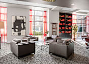 Thumbnail 33 of 35 - A living room with two grey couches and a large abstract painting on the wall.