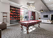 Thumbnail 35 of 35 - A pool table is in the middle of a room with a grey carpet.
