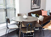 Thumbnail 4 of 7 - A dining table with four chairs around it.