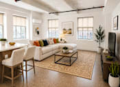 Thumbnail 6 of 20 - A living room with a white couch and a coffee table.