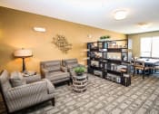Thumbnail 18 of 33 - a common area with couches and a table at The Flats at Cedar Grove, Eagan