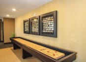 Thumbnail 22 of 33 - a community room with a shuffleboard table at The Flats at Cedar Grove, Eagan, MN