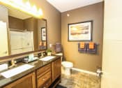 Thumbnail 12 of 33 - a bathroom with a large mirror and two sinks at The Flats at Cedar Grove, Minnesota, 55122