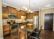 Thumbnail 1 of 33 - a kitchen with wooden cabinets and stainless steel appliances at The Flats at Cedar Grove, Minnesota, 55122