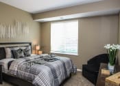 Thumbnail 14 of 33 - a bedroom with a bed and a window at The Flats at Cedar Grove, Eagan, MN, 55122