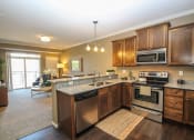 Thumbnail 3 of 33 - a kitchen with wooden cabinets and stainless steel appliances at The Flats at Cedar Grove, Eagan, 55122