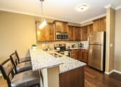 Thumbnail 2 of 33 - a kitchen with a large island and stainless steel appliances at The Flats at Cedar Grove, Eagan, MN, 55122