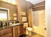 Thumbnail 6 of 33 - a bathroom with a toilet a sink and a bathtub at The Flats at Cedar Grove, Eagan, Minnesota