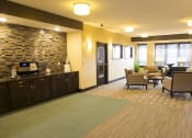 Thumbnail 29 of 33 - a reception area with chairs and a coffee bar at The Flats at Cedar Grove, Minnesota, 55122