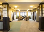 Thumbnail 28 of 33 - a large common area with chairs and tables at The Flats at Cedar Grove, Eagan, MN