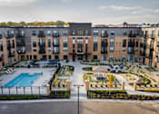 Thumbnail 39 of 43 - an aerial view of a large apartment complex with a swimming pool at The Gallery Apartments, Burnsville, Minnesota