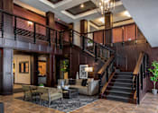 Thumbnail 36 of 43 - a lobby with a staircase and couches at The Gallery Apartments, Minnesota