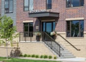 Thumbnail 39 of 44 - the entrance of a brick building with a sign that says victoria park  at Victoria Park and V2 Apartments, Minnesota, 55102