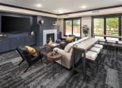 Thumbnail 14 of 42 - Clubhouse interior with lounger area and fireplace at The Whitley in St. Paul, MN.