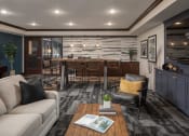 Thumbnail 22 of 42 - Lounge area with couch, tables, and chairs, with breakfast bar  at The Whitley, St. Paul, MN