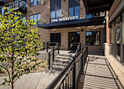 Thumbnail 35 of 42 - The Whitley building has a black railing and a tree in front of it.