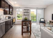 Thumbnail 4 of 42 - View of kitchen and living room area looking onto the balcony  at The Whitley, St. Paul, MN