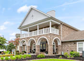 Thumbnail 1 of 25 - A house with a balcony and arched doorways.