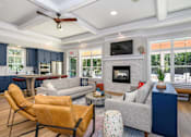 Thumbnail 6 of 35 - A living room with a fireplace and a television at The Promenade at Easton Apartments, Easton, 21601