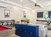Thumbnail 8 of 35 - A room with a pool table and a blue cabinet at The Promenade at Easton Apartments, Easton, MD