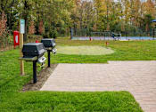 Thumbnail 33 of 35 - A park with a bench and a trash can at The Promenade at Easton Apartments, Easton Maryland