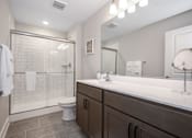 Thumbnail 15 of 35 - A bathroom with a toilet, sink, and shower at The Promenade at Easton Apartments, Easton Maryland
