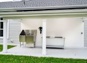Thumbnail 24 of 35 - A white garage with a white door and a white bench inside at The Promenade at Easton Apartments, Maryland
