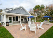 Thumbnail 20 of 35 - A house with a patio and chairs at The Promenade at Easton Apartments, Easton Maryland