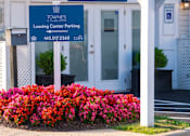 Thumbnail 34 of 50 - the entrance to the leasing center of the towers leasing center parking building at Townes at Village Center Apartments, Maryland, 21136