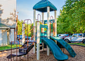 Thumbnail 14 of 50 - Playground with slides and a climb up at Townes at Village Center Apartments, Reisterstown