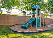 Thumbnail 12 of 50 - a playground with a slide in a park at Townes at Village Center Apartments, Reisterstown, 21136