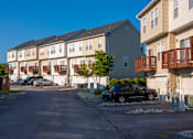 Thumbnail 50 of 50 - a row of houses on the side of a street at Townes at Village Center Apartments, Reisterstown, Maryland