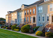 Thumbnail 42 of 50 - Building exterior with garden at Townes at Village Center, Reisterstown, 21136