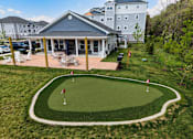 Thumbnail 31 of 35 - A small putting green is in front of a house.