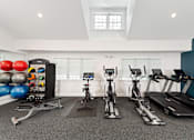 Thumbnail 29 of 35 - A spacious gym with a variety of exercise equipment including treadmills, stationary bikes, and a rowing machine. at Spa Cove Apartments, Annapolis, 21403