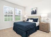 Thumbnail 15 of 20 - A bedroom with a bed, nightstand, and window with blinds. at Forge Overlook, Halethorpe