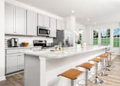 Thumbnail 6 of 20 - A kitchen with white cabinets and a marble countertop. at Forge Overlook, Halethorpe