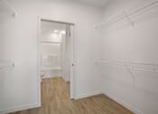 Thumbnail 5 of 19 - A white room with a doorway leading to another room.