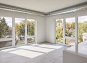Thumbnail 13 of 19 - A room with white walls and a white table with a white box on it.