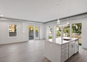 Thumbnail 11 of 19 - A modern kitchen with a sink and cabinets.