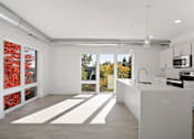 Thumbnail 2 of 19 - A kitchen with white cabinets and a white counter top.